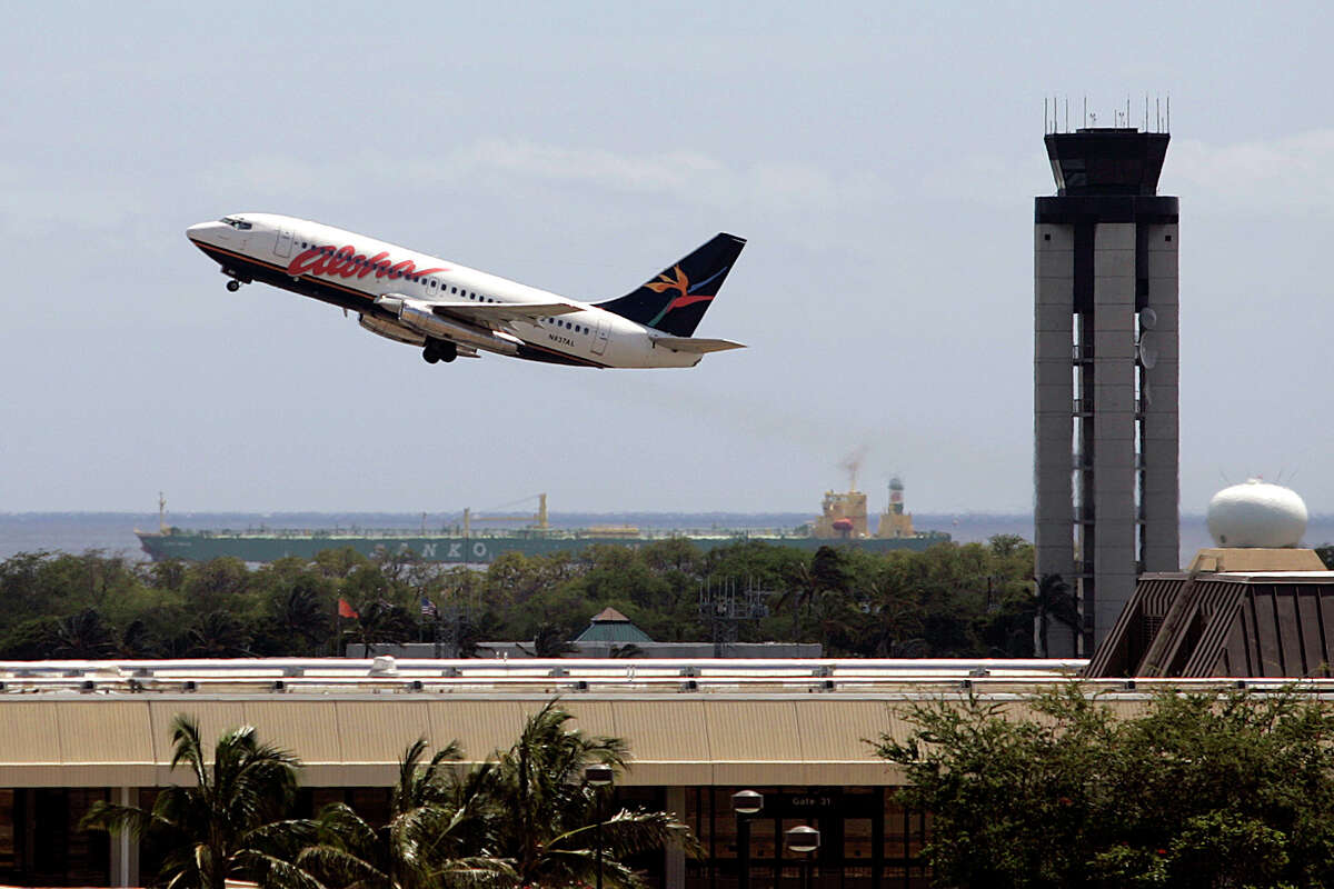 An Aloha Airlines passenger plane departs the Honolulu International Airport, Sunday, March 30, 2008, in Honolulu. 