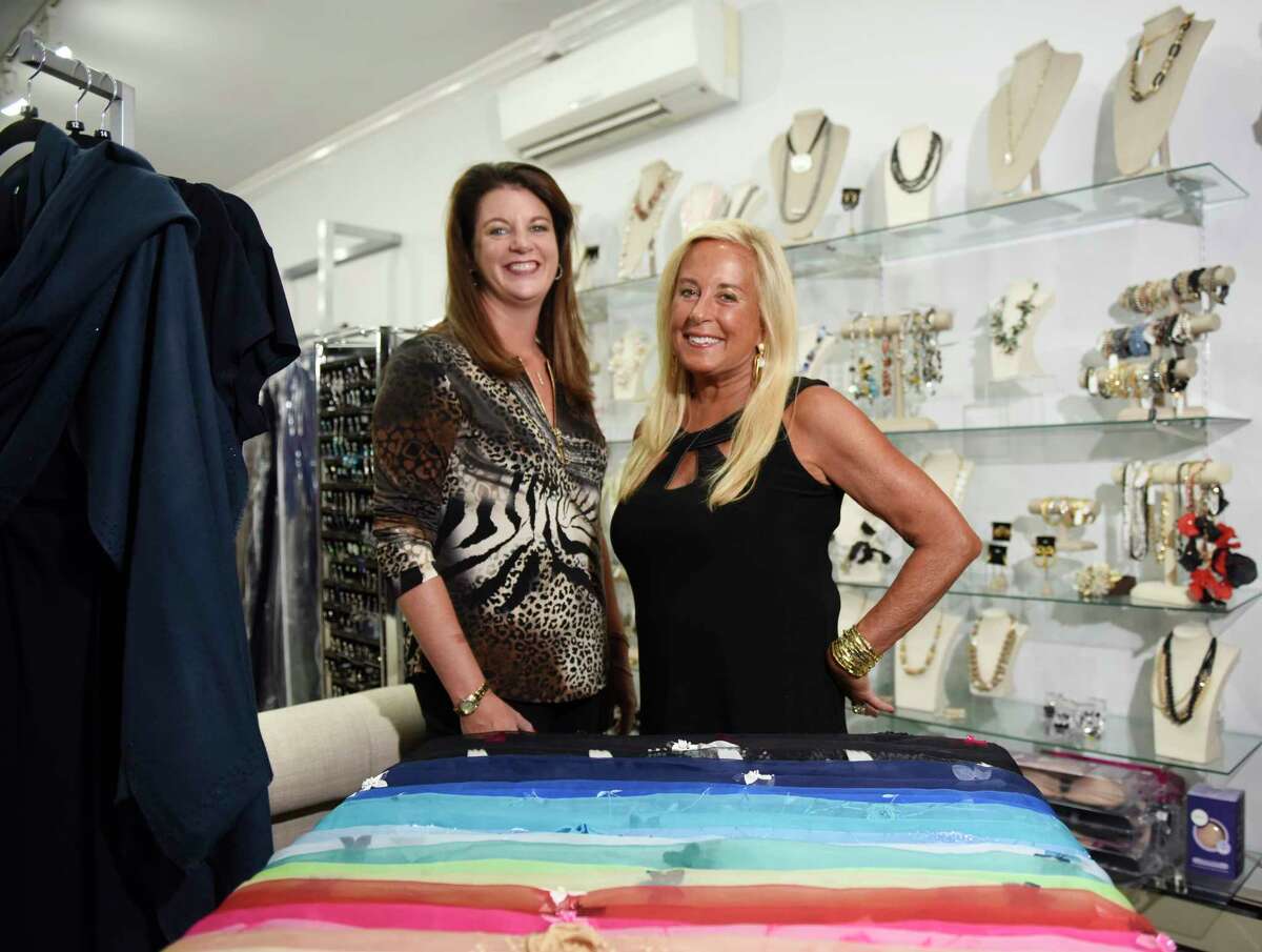 Longtime owner Erica Jensen, right, and new owner Corrie Bellardinelli pose together at Helen Ainson in Darien, Conn. Wednesday, Sept. 14, 2022.