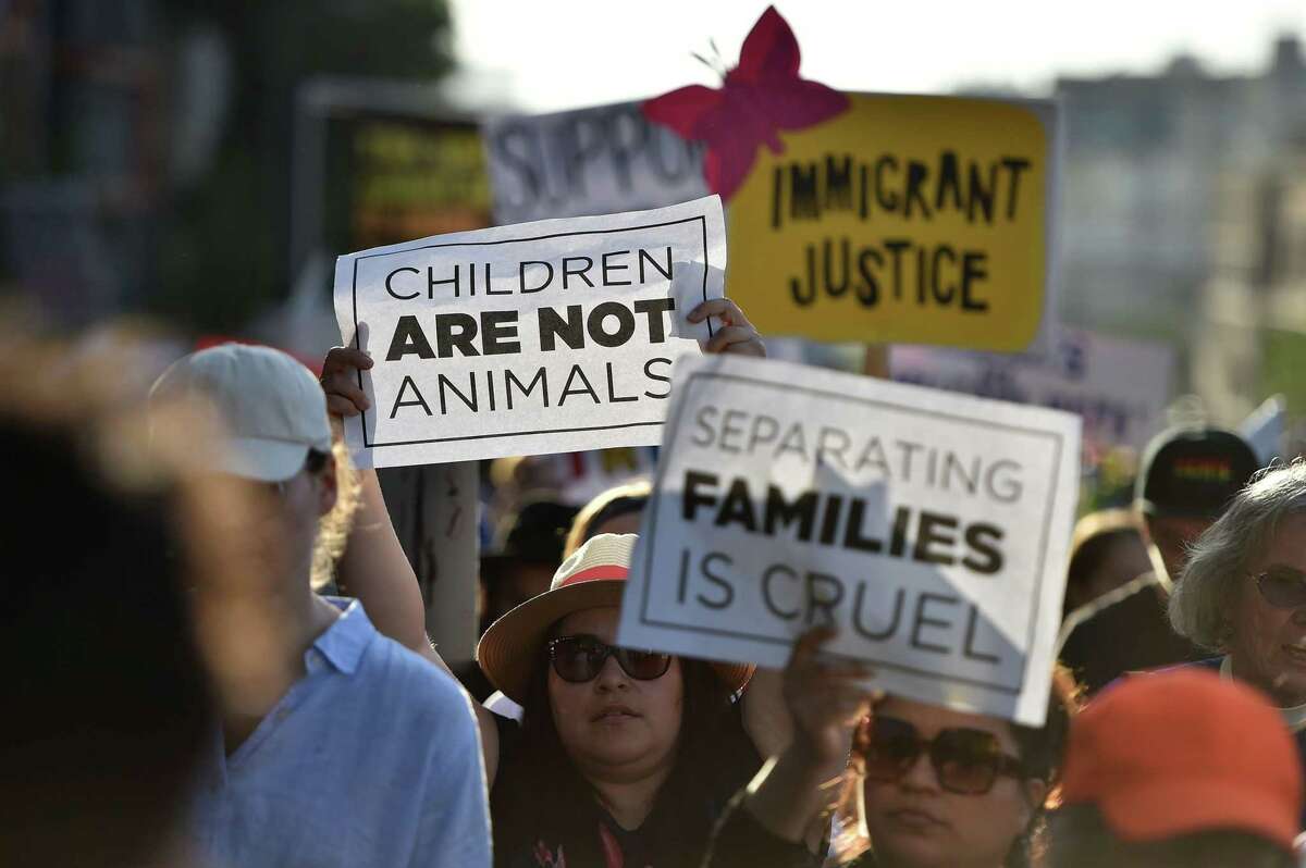 Critics of a U.S. government policy that separates children their parents when they cross the border protest during a Families Belong Together march in Los Angeles on June 14, 2018.