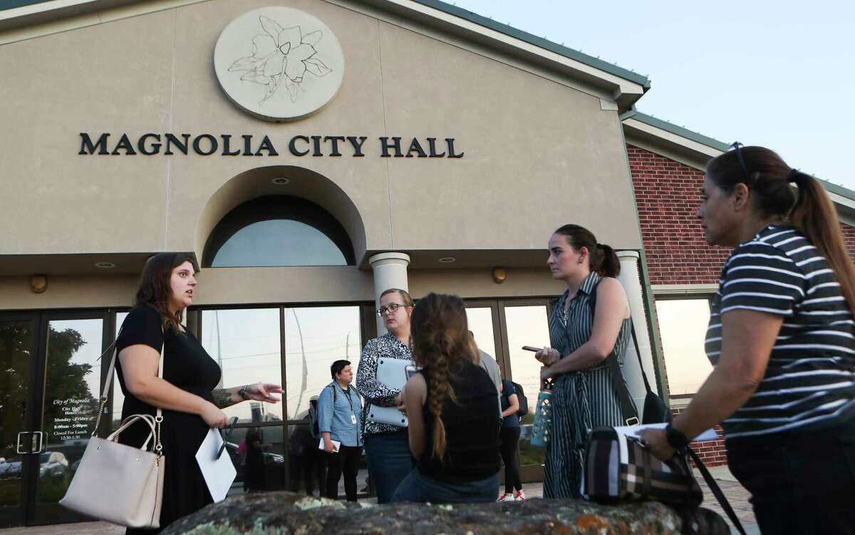 Madison Buentello, left, speaks with fellow residents of the Mill Creek and Magnolia Ridge subdivisions after they called on Magnolia City Council members to further investigate their water meters after experiencing high water bills, Tuesday, Sept. 13, 2022, in Magnolia.