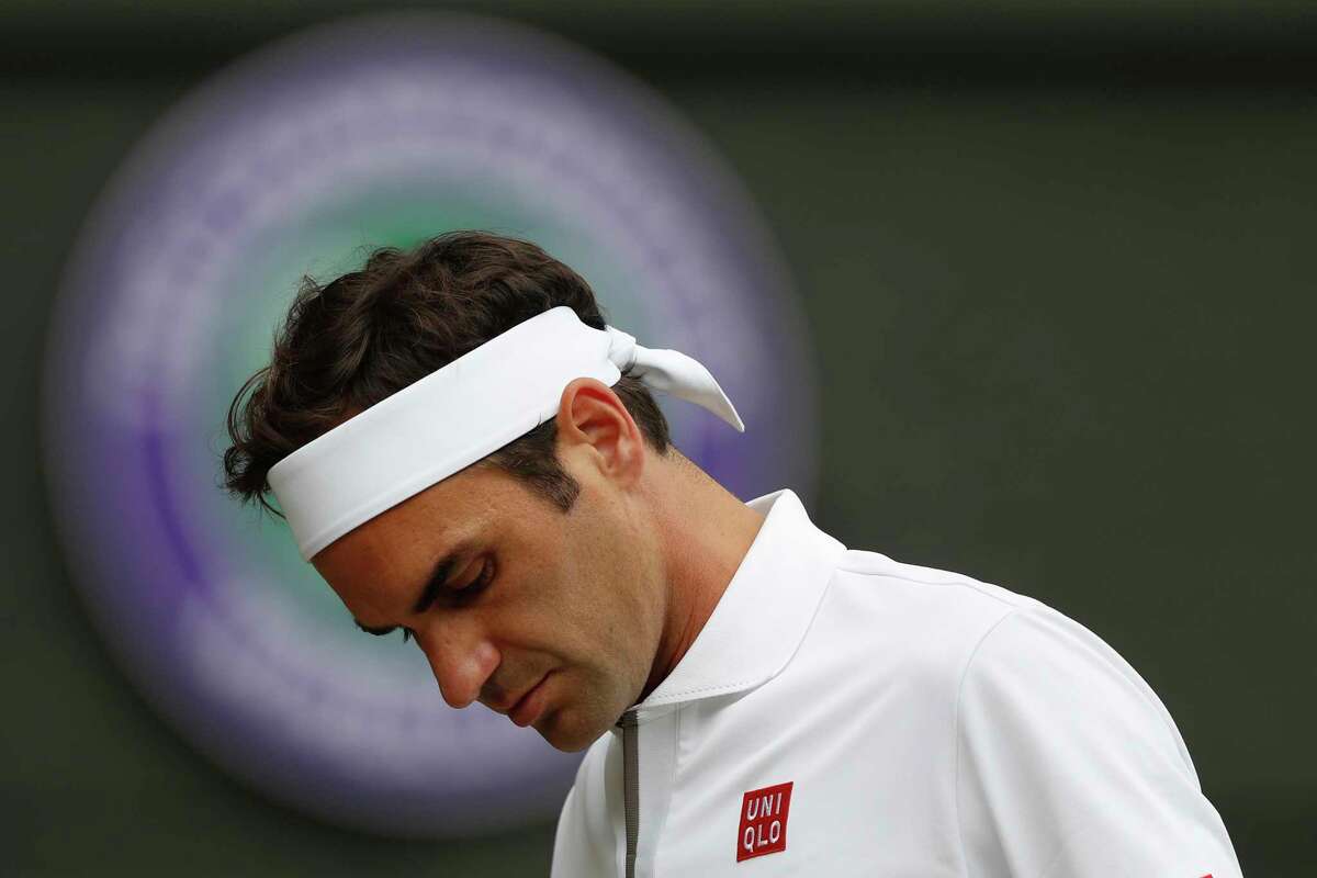 Switzerland's Roger Federer is dejected after losing a point to Serbia's Novak Djokovic during the men's singles final match of the Wimbledon Tennis Championships in London, Sunday, July 14, 2019.