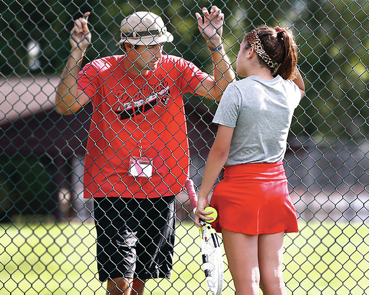Robert Logan discusses things with one of his Alton High players during his coaching days with the Redbirds. The annual Robert Logan Invitational is set for Saturday.
