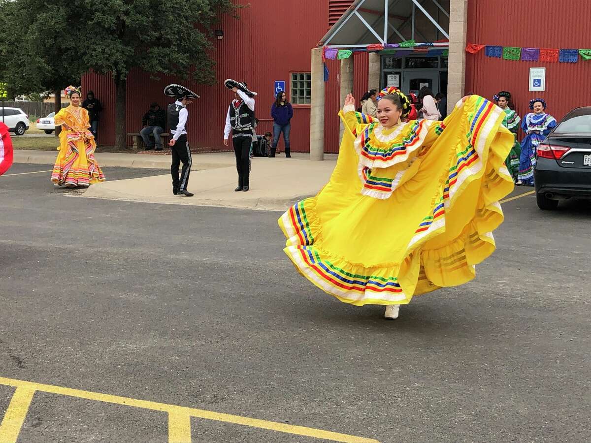 A folkloric dancer from the Hispanic Cultural Center of Midland throws her dress in the air during a show at the 2021 Familia Fest, hosted by Casa de Amigos. 