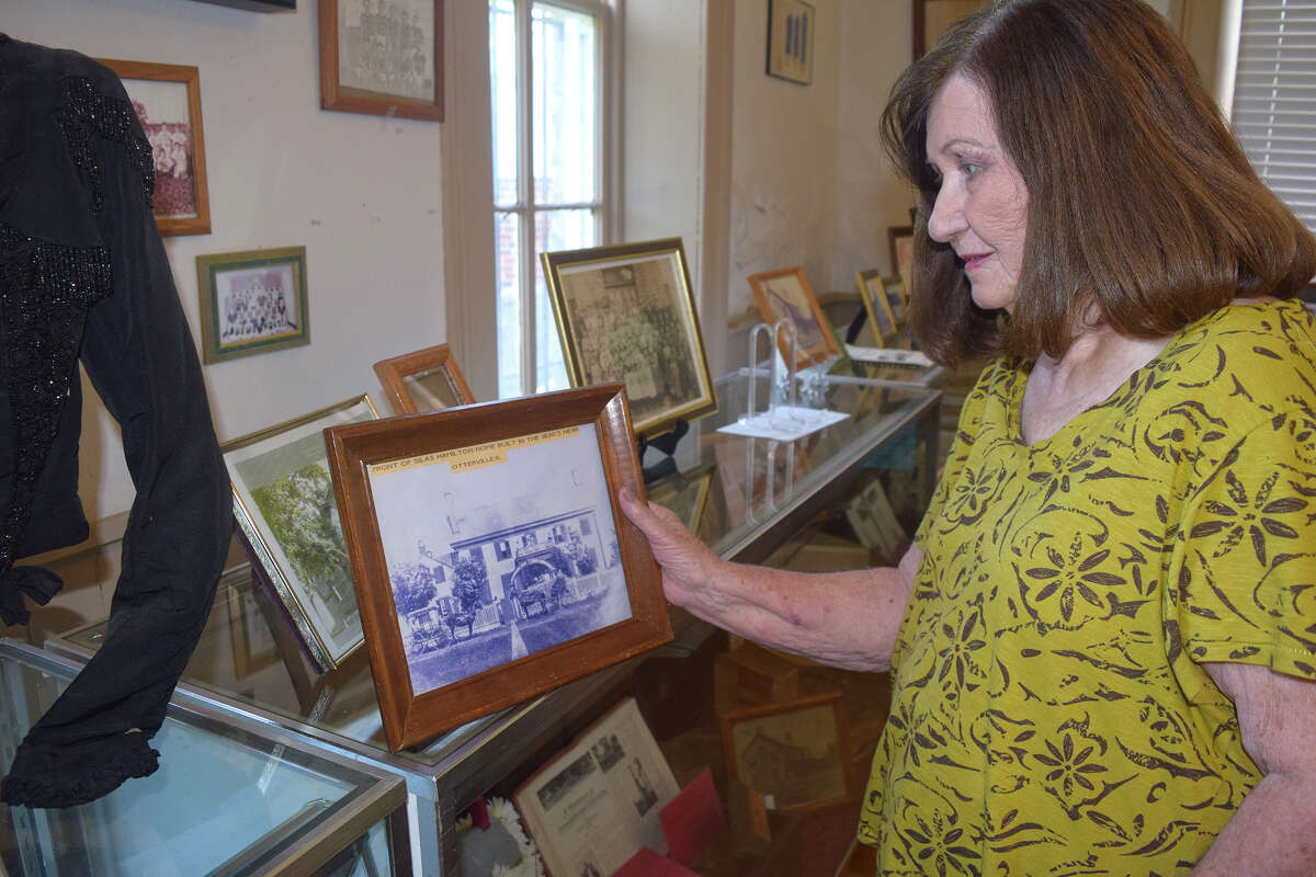 Otter Creek Historical Society member Jean Marshall holds a picture of Silas Hamilton's home at Hamilton Primary School in Otterville.