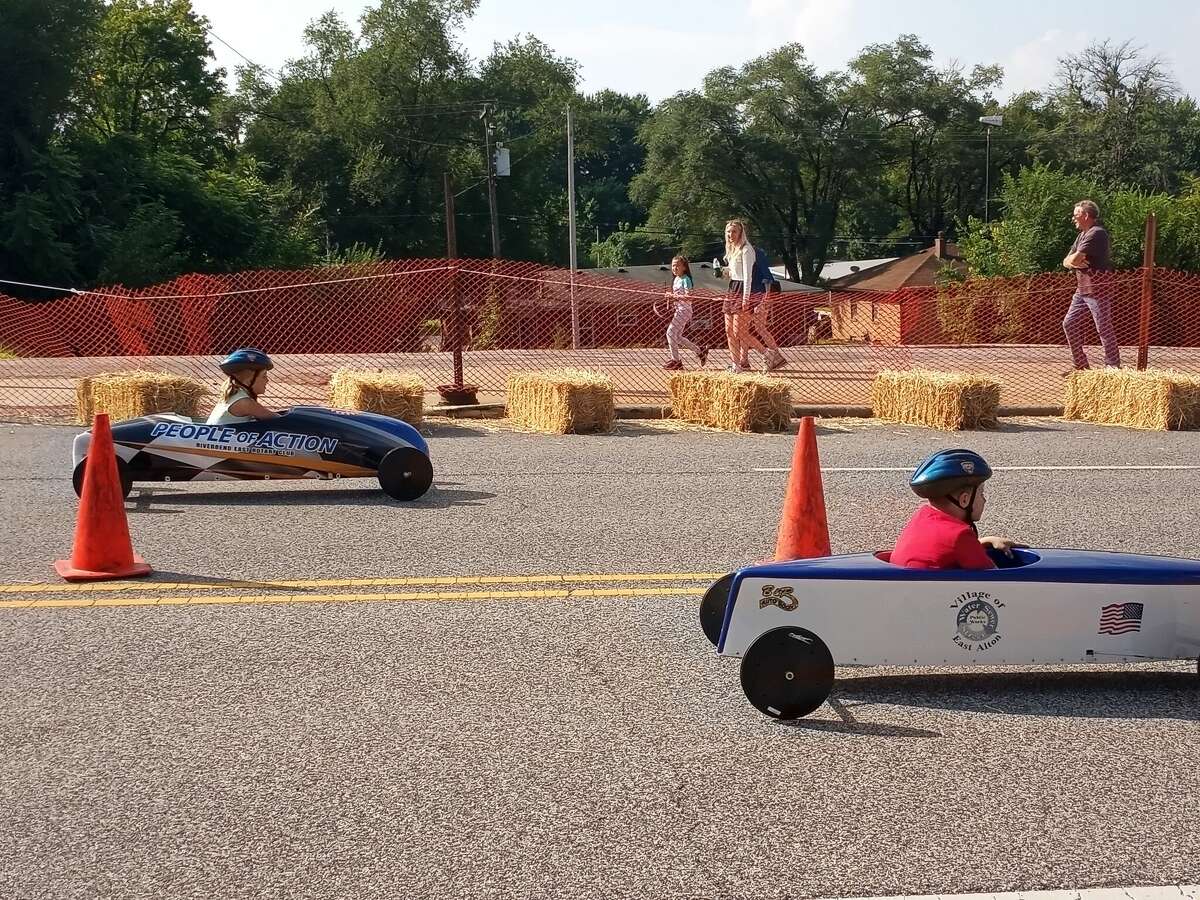 Two sponsored racers race down Berkshire Hill at the Soapbox Race Festival in East Alton