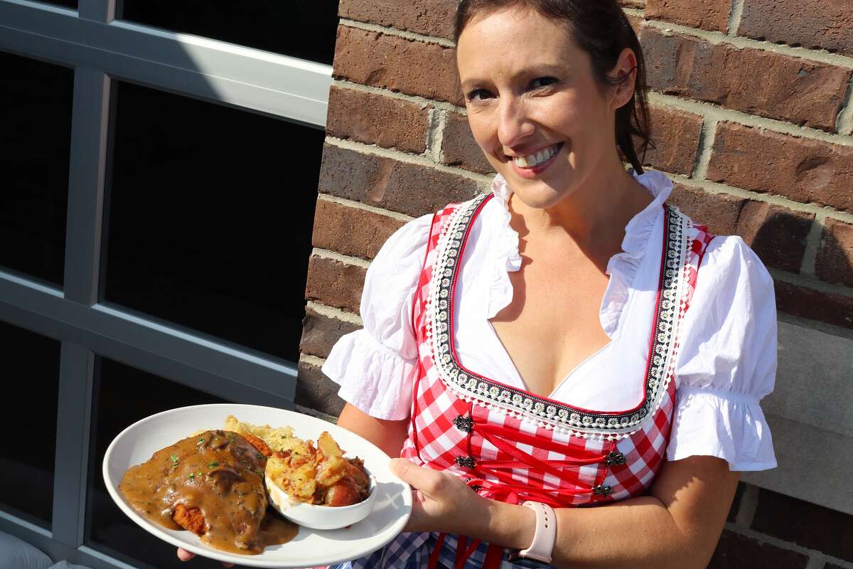 Colleen Gannaway shows off a plate of Brown Iron Brewhouse's German food.