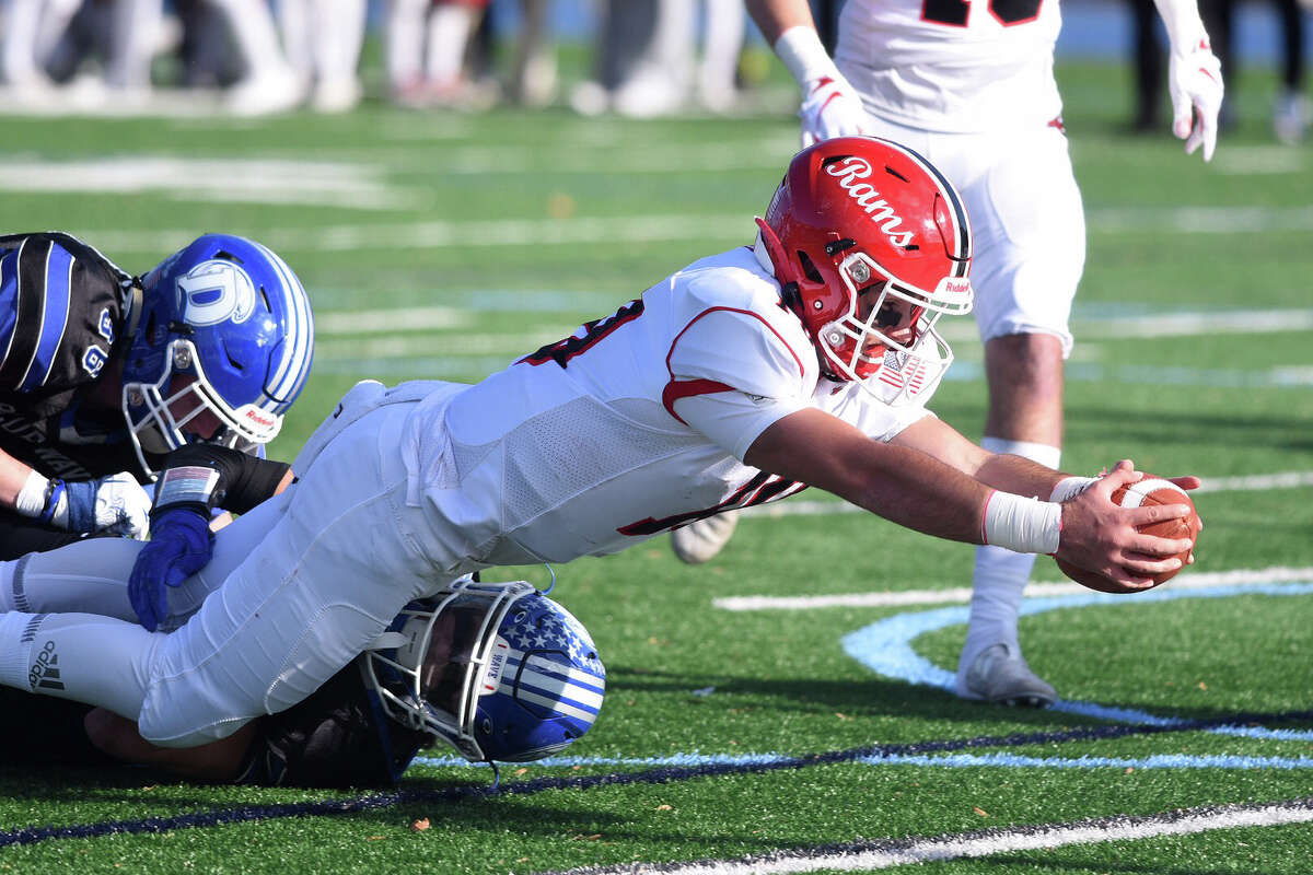 New Canaan quarterback Drew Pyne (10) stretches for a touchdown during the Rams' annual Turkey Bowl football game against Darien at Darien High School on Thursday, November 28, 2019.