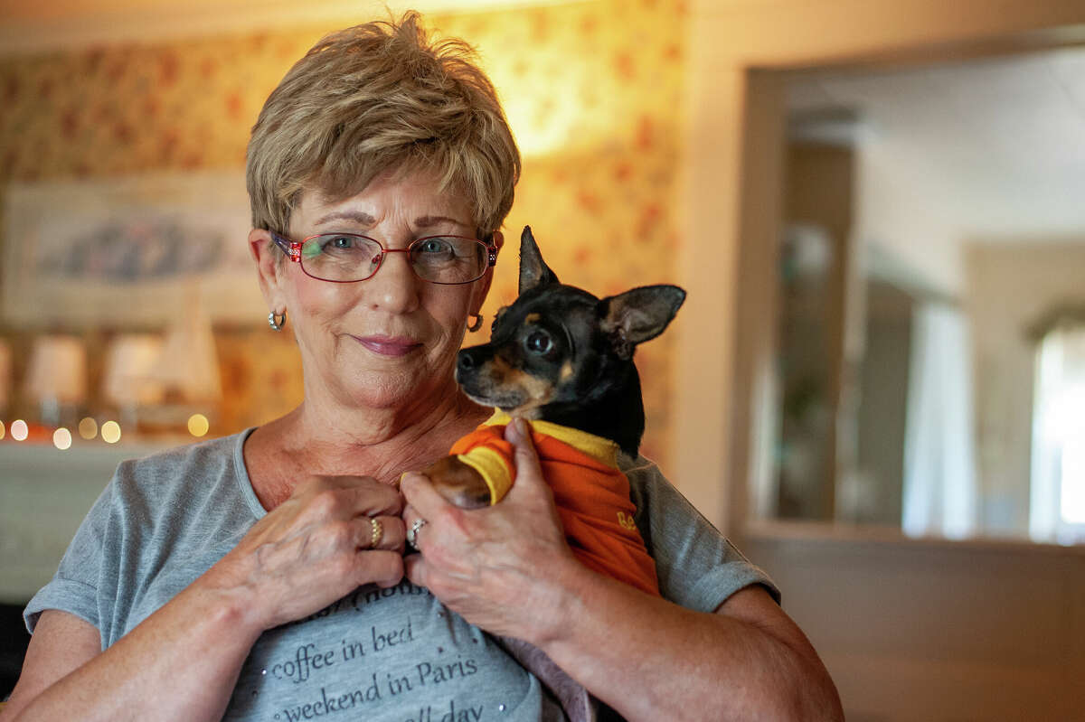 Midland resident Dawn Hartley poses with her four-year-old pet Chihuahua, Buddy, on Sept. 14, 2022 in her Midland home. Buddy recently went missing for three weeks before being found in an old car.