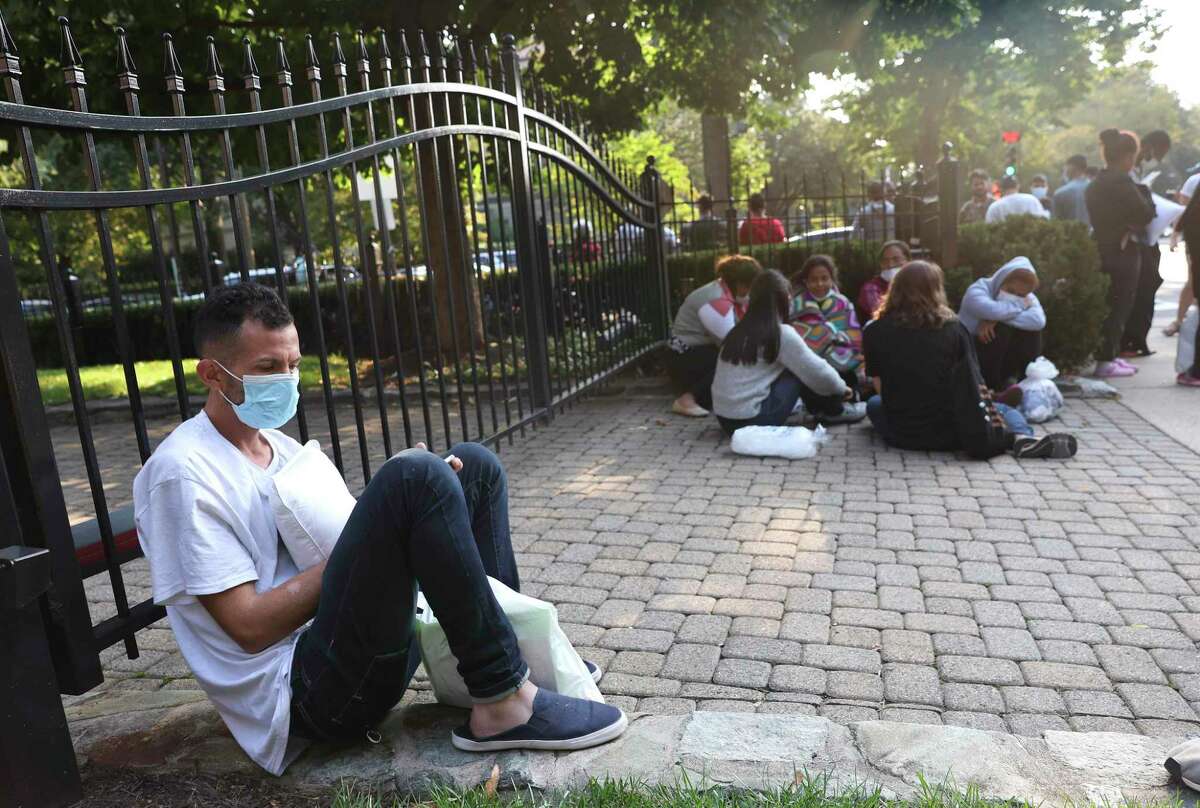 Immigrants from Central and South America wait near the residence of Vice President Kamala Harris after being dropped off in Washington, D.C. Texas Gov. Greg Abbott dispatched buses carrying migrants from the southern border to Harris’ home early Thursday morning.