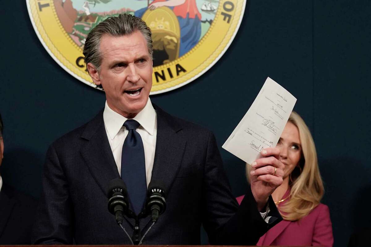 California's pro-choice billboards debut in anti-abortion states. California Gov. Gavin Newsom displays a bill he signed that shields abortion providers and volunteers in California from civil judgments from out-of-state courts during a news conference in Sacramento on June 24, 2022.