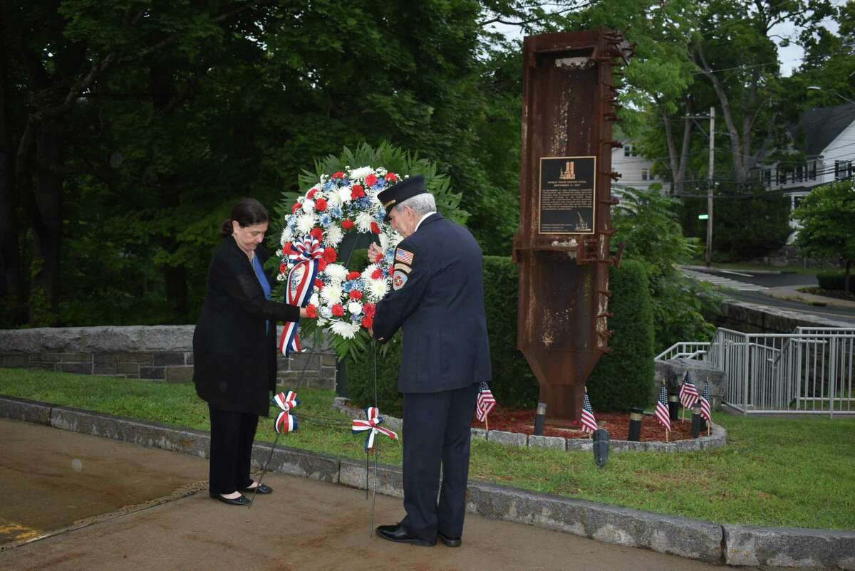 Glenville Volunteer Fire Company President Sandy Kornberg, right, and Susan Wohlforth place a memorial wreath at a memorial made of a piece of World Trade Center steel outside the Glenville fire house as part of a 9/11 remembrance ceremony.