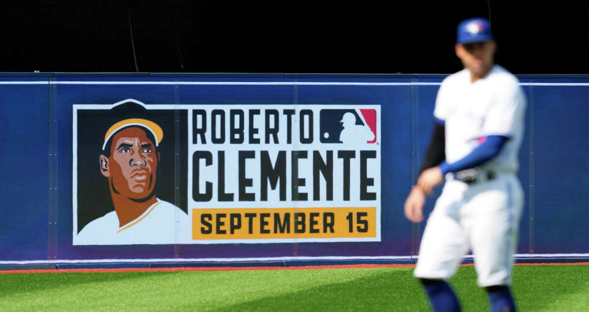 A Roberto Clemente Day sign is seen behind George Springer #4 of the Toronto Blue Jays before the Blue Jays play the Tampa Bay Rays in their MLB game at the Rogers Centre on September 15, 2022 in Toronto, Ontario, Canada. (Photo by Mark Blinch/Getty Images)