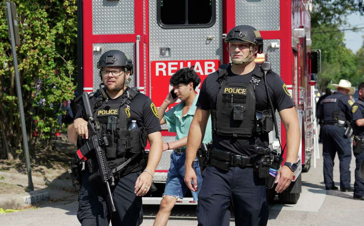 Houston Police Department officers remain on site at Arlington and E. 14th Streets after an active shooter scare forces Heights High School and nearby campuses into lockdown Tuesday, Sept. 13, 2022, in Houston.