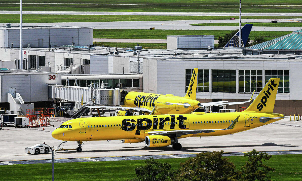 A Spirit Airlines aircraft is towed from the terminal gate at Orlando International Airport.