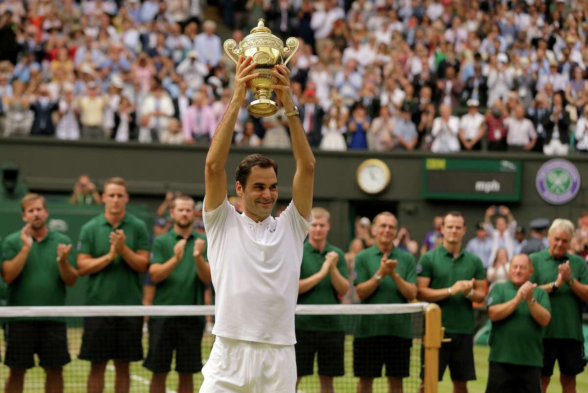 Roger Federer displays the champion’s trophy after winning the men’s singles title in 2017, his last at Wimbledon.