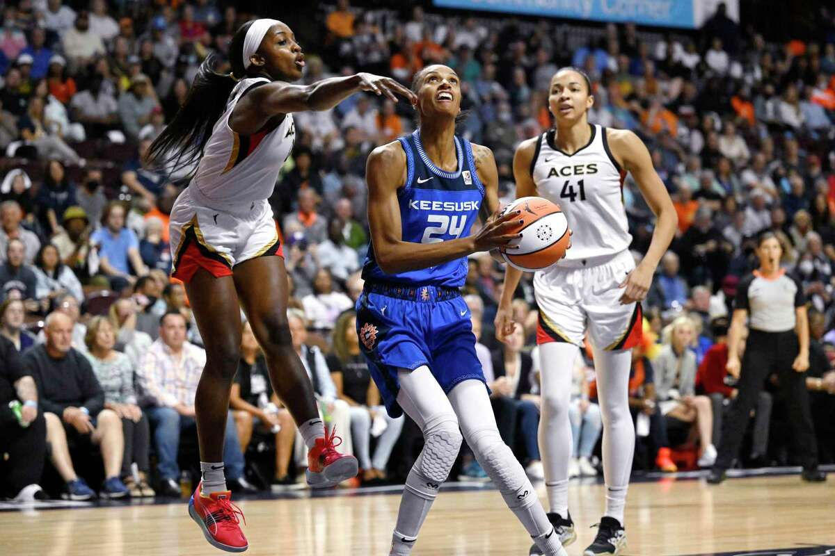 Connecticut Sun's DeWanna Bonner, looks up to shoot as Las Vegas Aces' Jackie Young, left, defends during the first half in Game 3 of a WNBA basketball final playoff series, Thursday, Sept. 15, 2022, in Uncasville, Conn. (AP Photo/Jessica Hill)