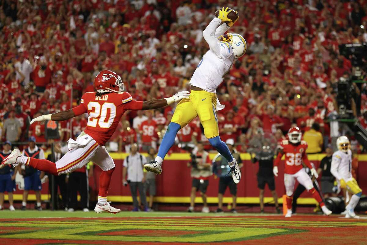KANSAS CITY, MISSOURI - SEPTEMBER 15: Joshua Palmer #5 of the Los Angeles Chargers catches a pass over Justin Reid #20 of the Kansas City Chiefs for a touchdown during the fourth quarter at Arrowhead Stadium on September 15, 2022 in Kansas City, Missouri. (Photo by Jamie Squire/Getty Images)
