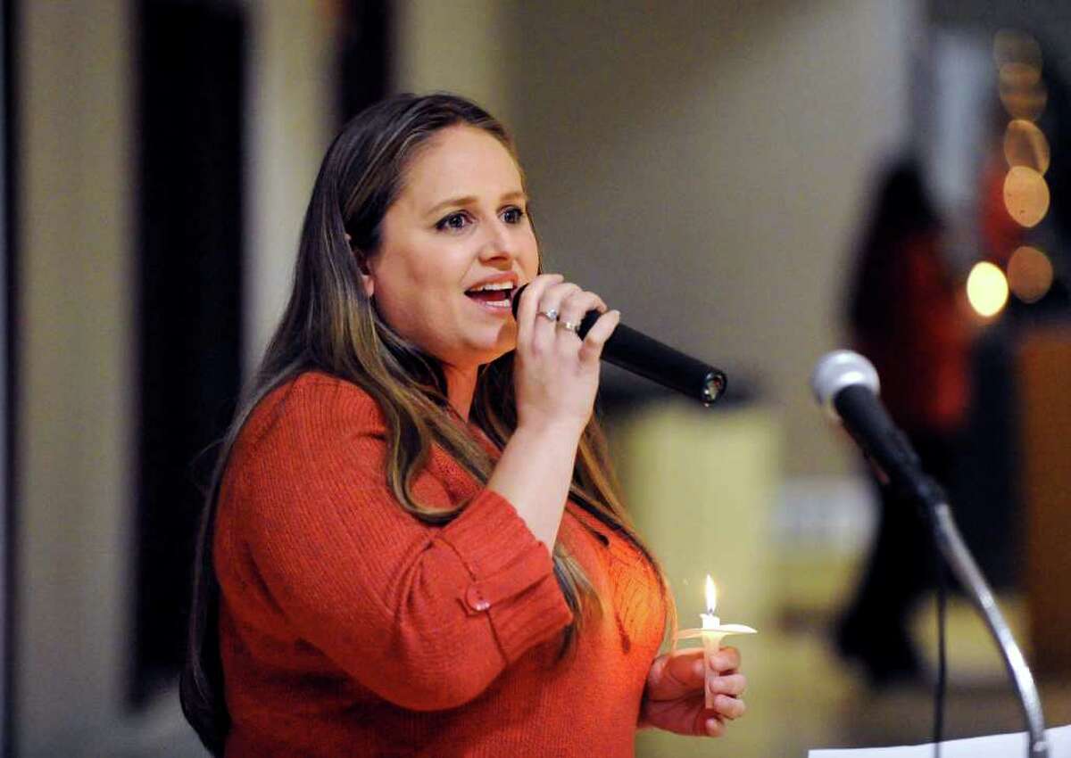 Heather Brown a staff member of the YWCA of Greenwich sings the Sarah Mclachlan song, "Angel" during the YWCA of Greenwich Domestic Abuse Services Annual Candlelight Vigil at the YWCA of Greenwich, Thursday evening, Oct. 7, 2010.
