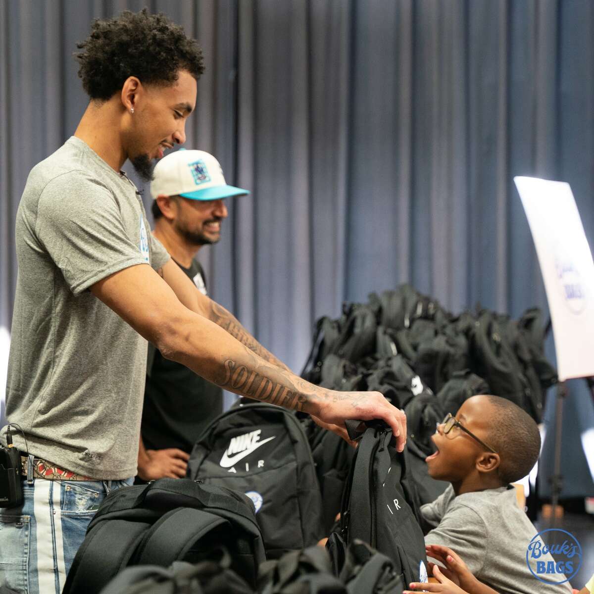James Bounkight hands the students special Air Jordan backpacks
