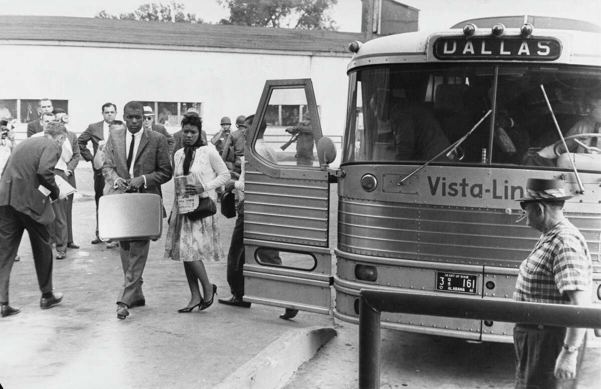 Civil rights activists known as the Freedom Riders disembark from their bus (marked Dallas), en route from Montgomery, Alabama, to Jackson, Mississippi, as they seek to enforce integration by using 'white only' waiting rooms at bus stations, 26th May 1961. (Photo by Daily Express/Archive Photos/Hulton Archive/Getty Images)