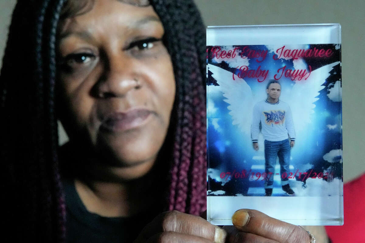 Larhonda Biggles holds a photo of her son, Jaquaree Simmons, as she talks about his death Saturday, Sept. 10, 2022 in Houston. 