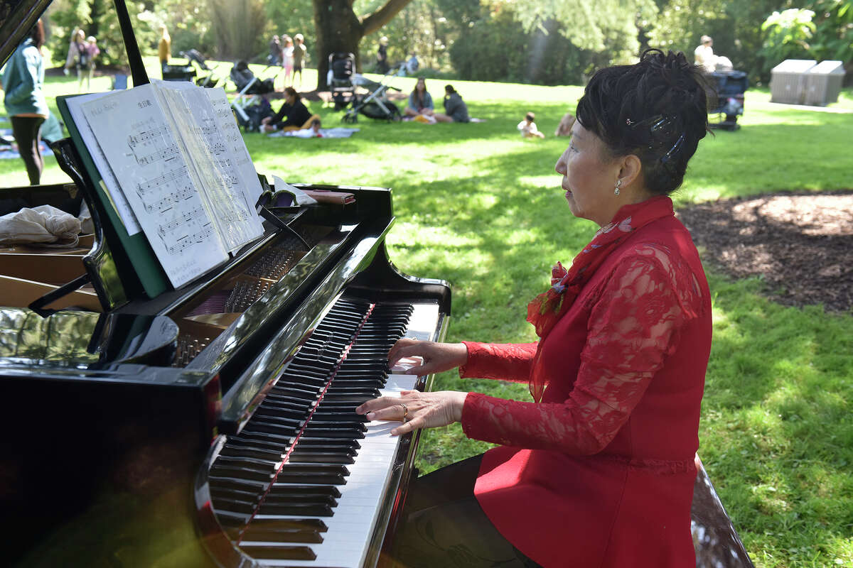 San Franciscan Grace Zheng plays a "Flower Piano" in the great meadow of the Botanical Gardens in Golden Gate Park, on Friday, Sept. 16, 2022. 