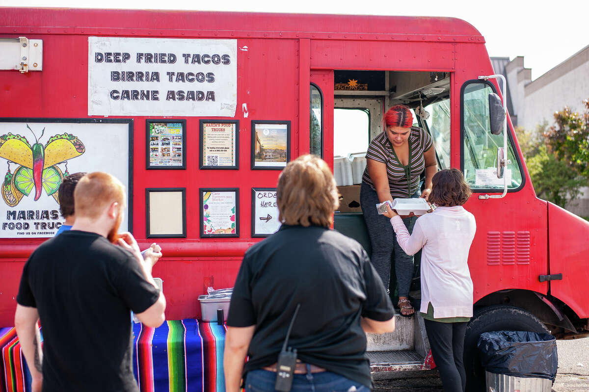 Saginaw resident Mariah Moacado serves food from Maria's Food Truck during the Midland County Crime Stoppers Fundraiser on Sept. 16, 2022 in a parking lot by Midland Mall.