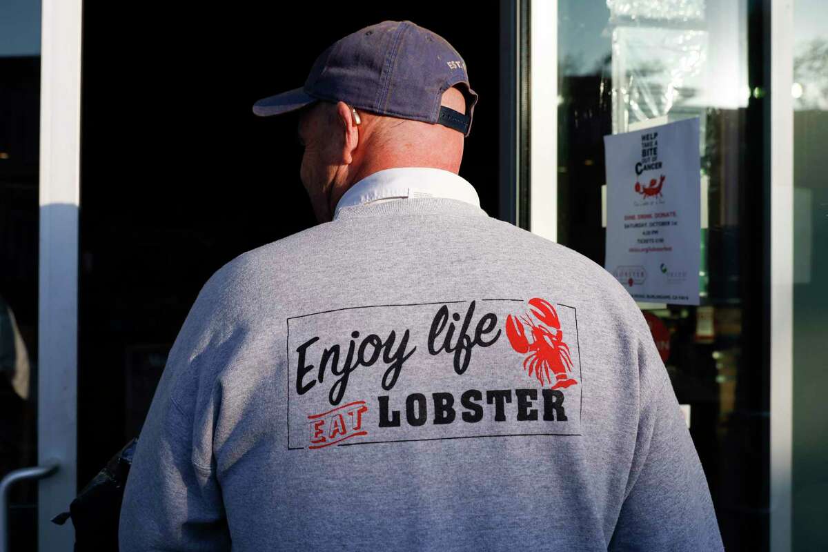 Marc Worrall wears a sweatshirt that reads “Enjoy life. Eat Lobster” at his business New England Lobster Co. in Burlingame, The environmental group Seafood Watch recently placed lobster on its “red list” to  discourage the purchase of Gulf of Maine lobster.