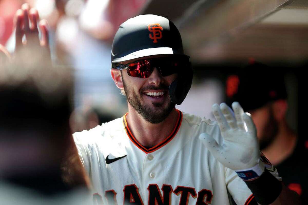San Francisco Giants' Kris Bryant is congratulated by teammates after hitting a home run against the Houston Astros during the third inning of a baseball game in San Francisco, Sunday, Aug. 1, 2021. (AP Photo/Jed Jacobsohn)