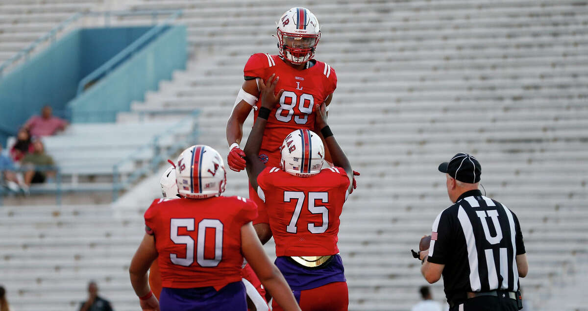 Lamar Texans Jadon Garza (89) is congratulated by Lamar Texans Dramodd Odoms (75) after a touchdown in the first half of the high school football game between the Lamar Texans and the Dobie Longhorns at Delmar Stadium in Houston, TX on Friday, September 16, 2022.