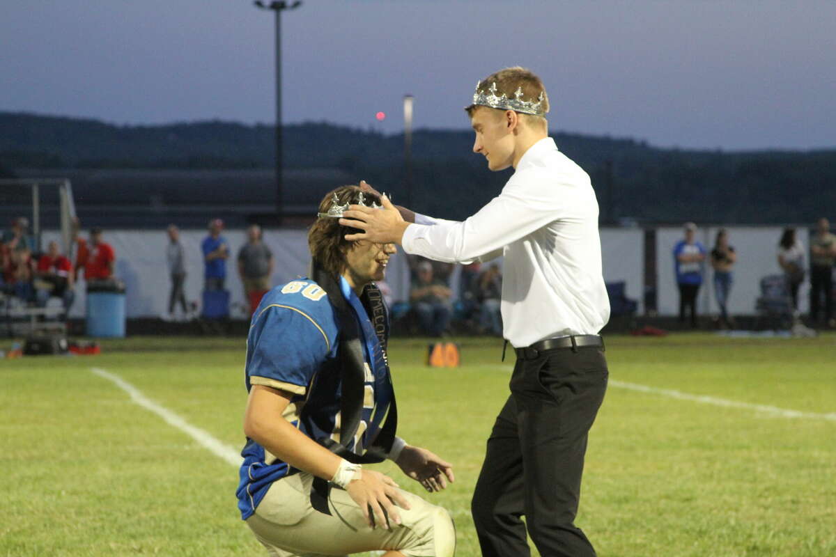 Alec Tabaczka (right), Onekama High School's 2021 Homecoming King, crowns Dante Gray Friday during halftime of the Portagers' homecoming game.