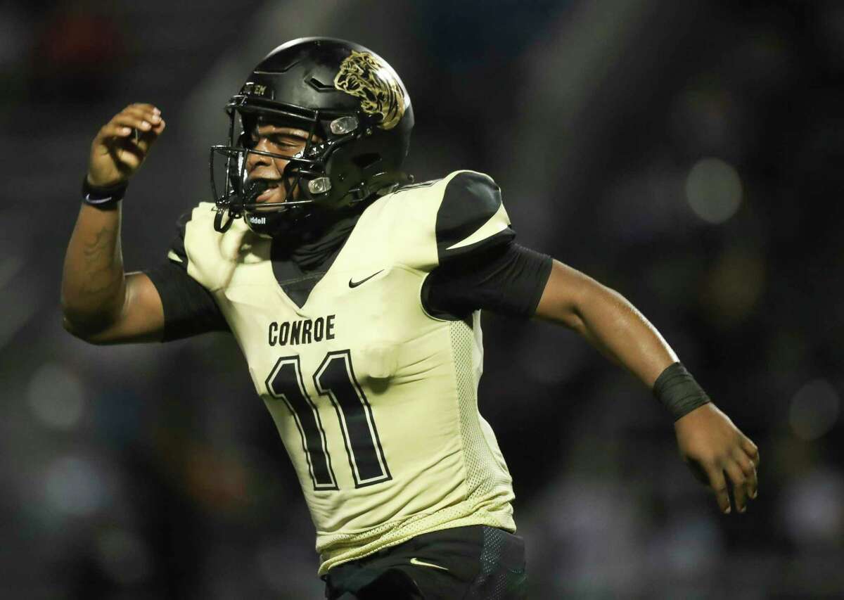 Conroe's Javarious Hatchett (11) reacts after scoring a 3-yard touchdown to give the Tigers’ a 27-24 lead in the fourth quarter of a District 13-6A high school football game at Buddy Moorhead Stadium, Friday, Sept. 16, 2022, in Conroe.
