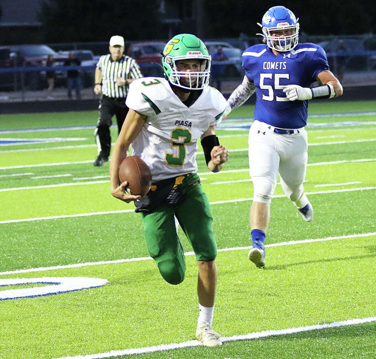 Southwestern quarterback Quinten Strohbeck (3) runs for a first down with Greenville's Sam Wagner in pursuit in the first half of a SCC game Friday night at Don Stout Field in Greenville.