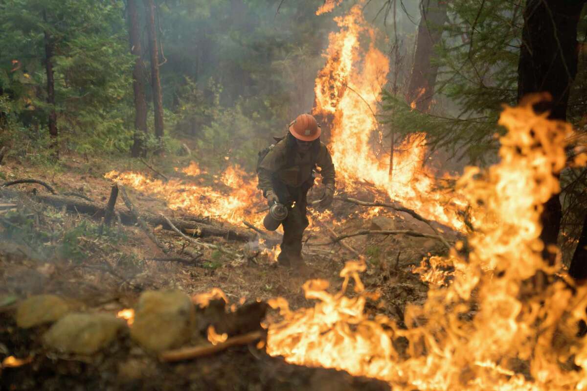 Firefighters work to contain the Mosquito Fire on Sept. 15, 2022 in Ramsey Crossing, Calif.