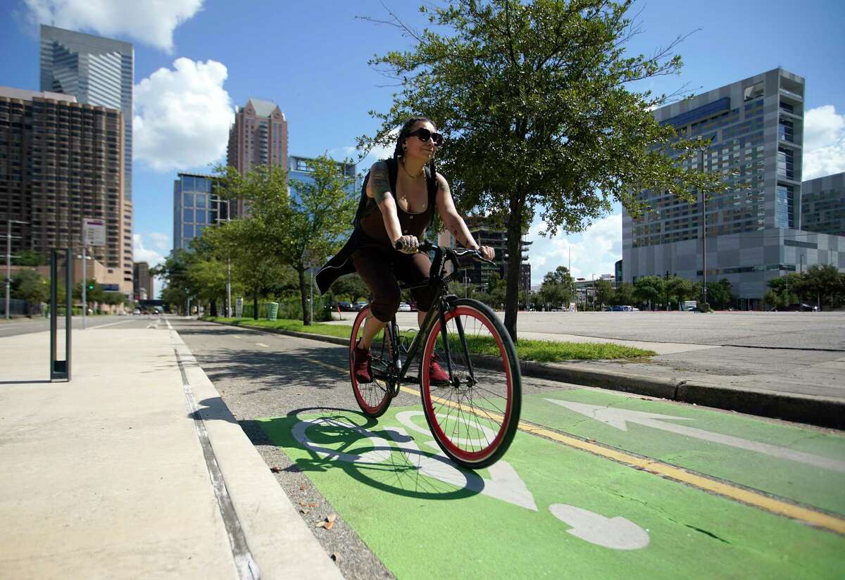 A bicyclist rides in a bike lane on Austin Street downtown on Saturday, Sept. 17, 2022 in Houston.
