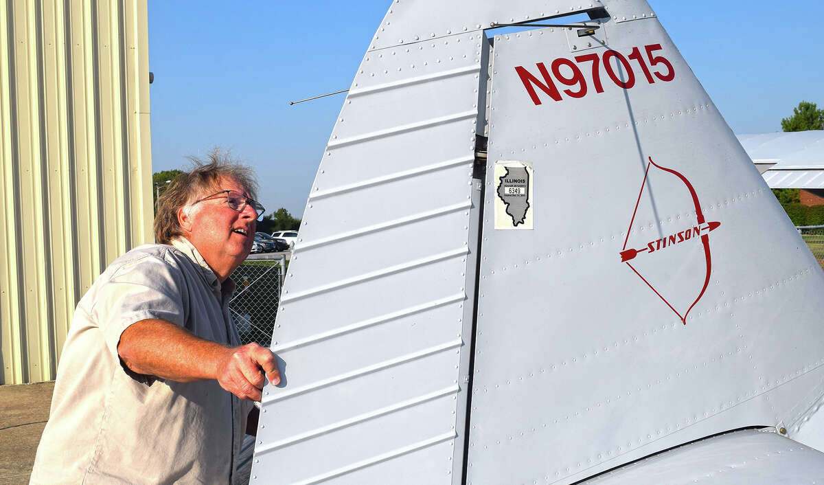 Randy Phillips of Quincy, a former president of the International Stinson Club, checks his 76-year-old Stinson airplane before taking off from Jacksonville Municipal Airport.