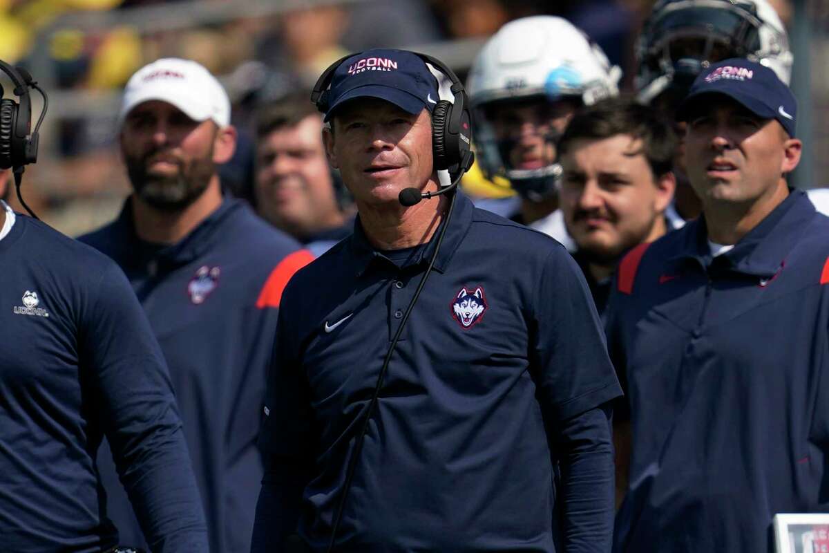 UConn football coach JIm Mora encouraging young team