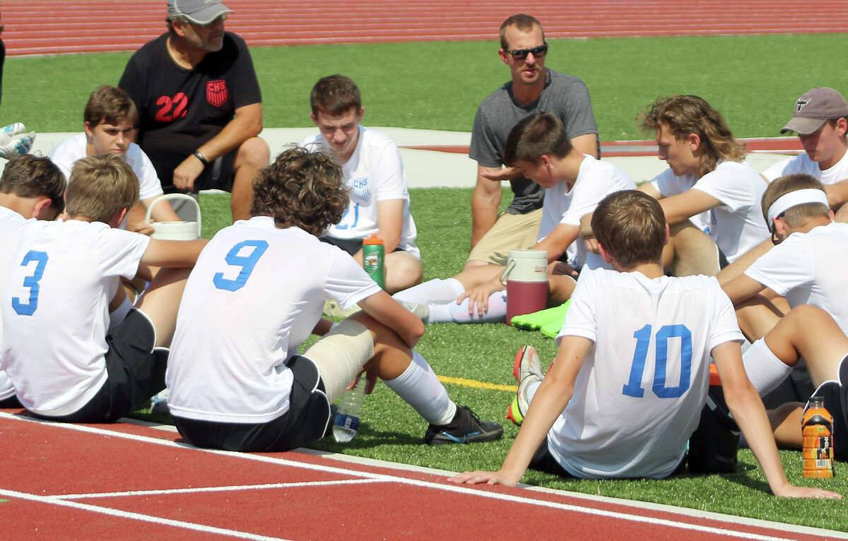 Carlinville Cavaliers coach Tim Johnson, center, speaks with his players during halftime of Saturday's prep soccer game against CM at Hauser Field.