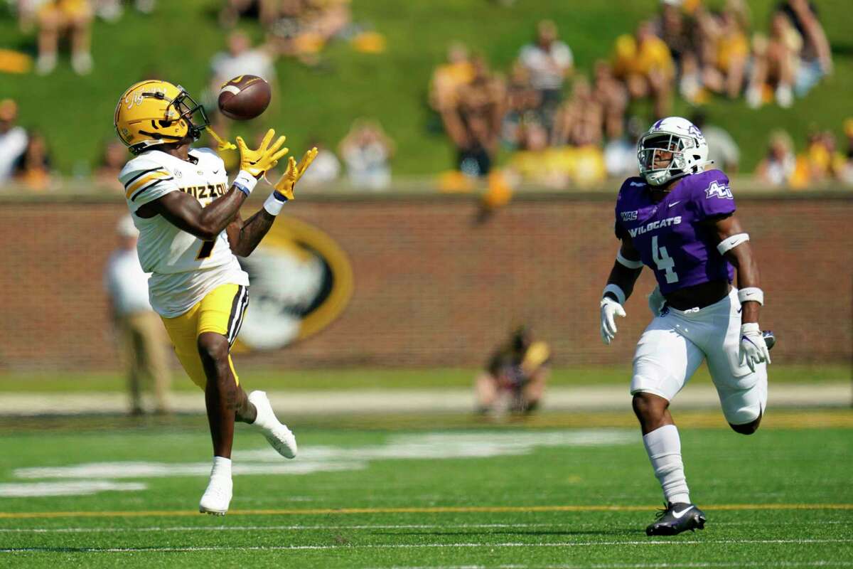 Missouri wide receiver Dominic Lovett, left, catches a 79-yard pass for a touchdown as Abilene Christian defensive back Anthony Egbo Jr. defends during the first half of an NCAA college football game Saturday, Sept. 17, 2022, in Columbia, Mo.