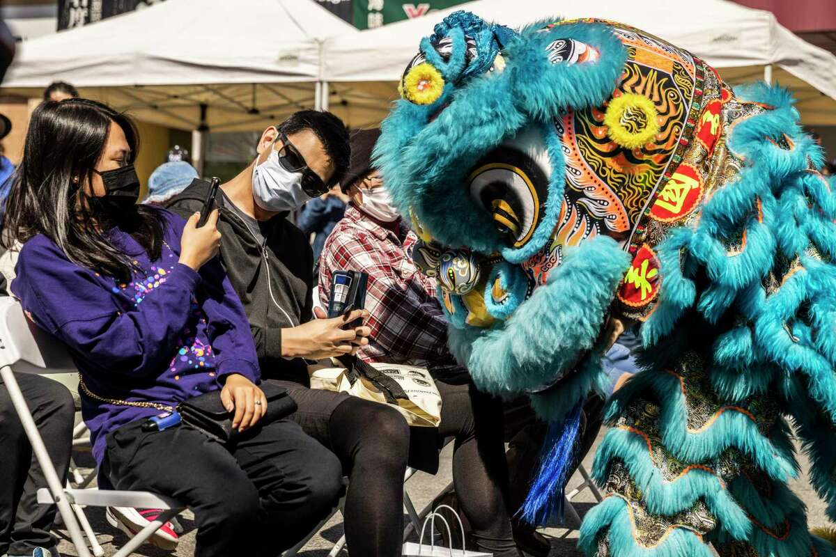 A dancing lion mingles with attendees of the Autumn Moon Festival in San Francisco’s Richmond District.