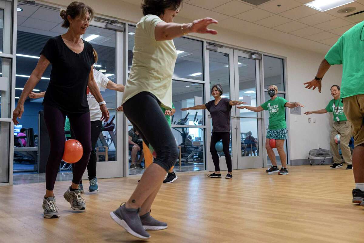 Students work out in the hip hop twerking class lead by Donna Gordon (not pictured) at the Walker Ranch Senior Center in San Antonio on Friday. Gordon credits her mother with teaching her discipline that lead her to graduate with honors from the University of Incarnate Word, become a trophy-winning bodybuilder and serve as fitness trainer to older residents at memory care and senior centers.