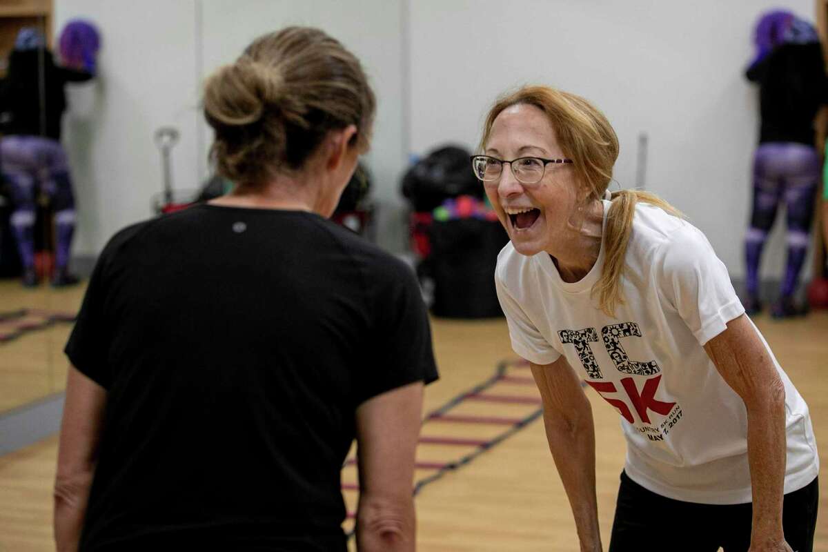 Katy Stephens, right, bursts into laughter with fellow student Annette Garza, left, in their hip hop T\twerking class at the Walker Ranch Senior Center in San Antonio on Friday. Gordon credits her mother with teaching her discipline that lead her to graduate with honors from the University of Incarnate Word, become a trophy-winning bodybuilder and serve as fitness trainer to older residents at memory care and senior centers.