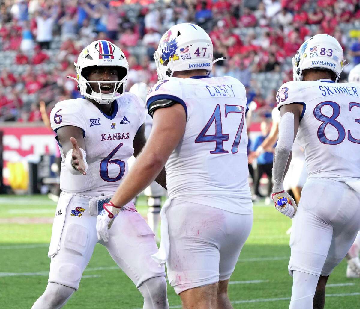 Kansas quarterback Jalon Daniels, celebrating a TD against UH earlier this season, could be back from injury for the Jayhawks to face Texas on Saturday.
