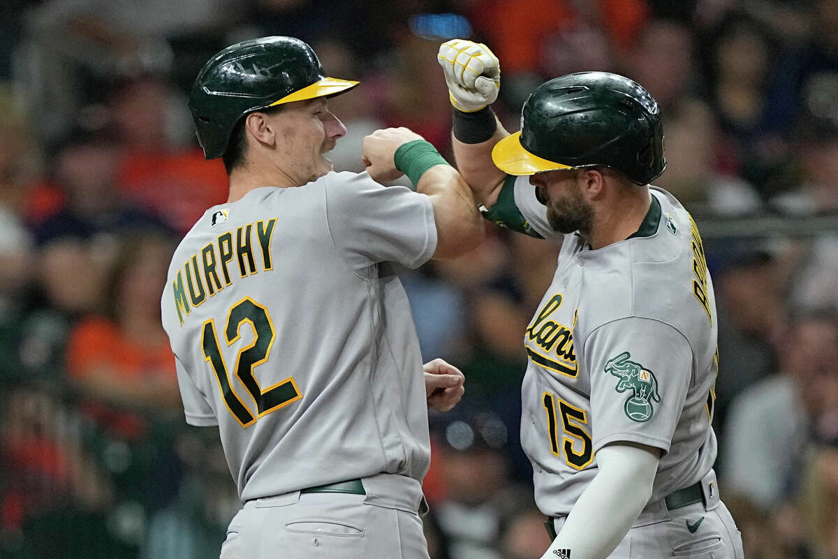Oakland Athletics' Seth Brown (15) celebrates with Sean Murphy after both scored on Brown's three-run home run against the Houston Astros during the fifth inning of a baseball game Saturday, Sept. 17, 2022, in Houston. (AP Photo/David J. Phillip)
