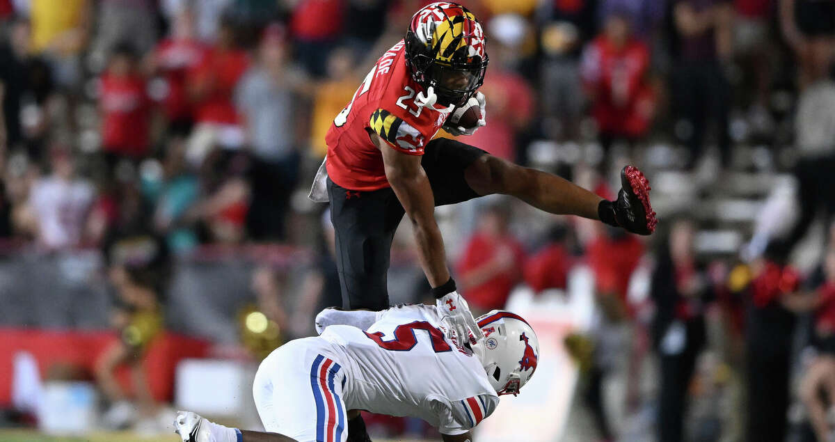 Maryland safety Beau Brade, top, intercepts a pass and is tackled by SMU's Moochie Dixon in the first half of an NCAA college football game, Saturday, Sept. 17, 2022, in College Park, Md. (AP Photo/Gail Burton)