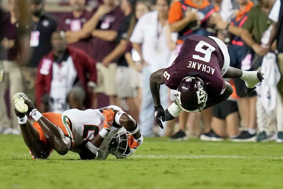 Texas A&M running back Devon Achane (6) is upended by Miami safety Kamren Kinchens (24) during the second quarter of an NCAA college football game Saturday, Sept. 17, 2022, in College Station, Texas.