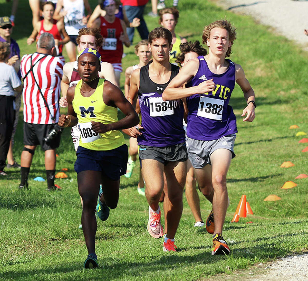CM's Jackson Collman (right) runs with Marion's Benja Stone (left) and Litchfield's Camden Quarton on Saturday at the Highland Invite at Fireman's Park in Alhambra.