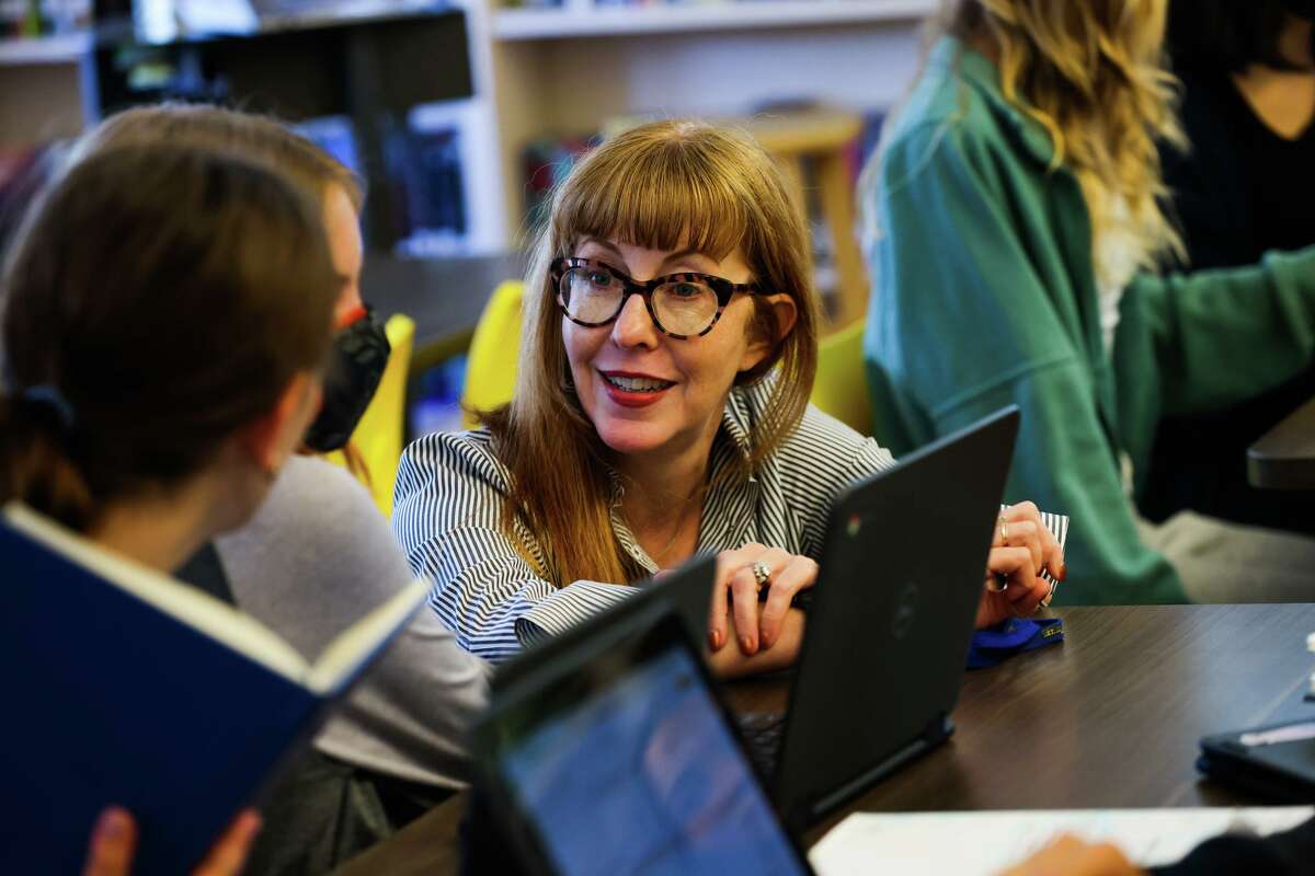 Principal Emily Leicham chats with students during eighth-grade media class at Roosevelt Middle School in San Francisco. The Salesforce Foundation, which funds the class, is giving millions of dollars to San Franciso and Oakland schools.