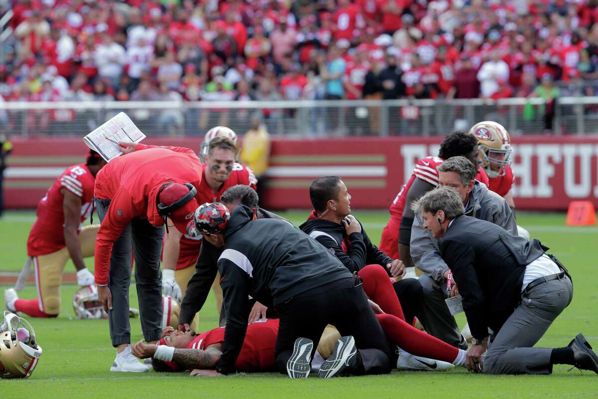 49ers head coach Kyle Shanahan checks on quarterback Trey Lance (5) who suffered a lower leg injury in the first half as the San Francisco 49ers played the Seattle Seahawks at Levi’s Stadium in Santa Clara, Calif., on Sunday, September 18, 2022.
