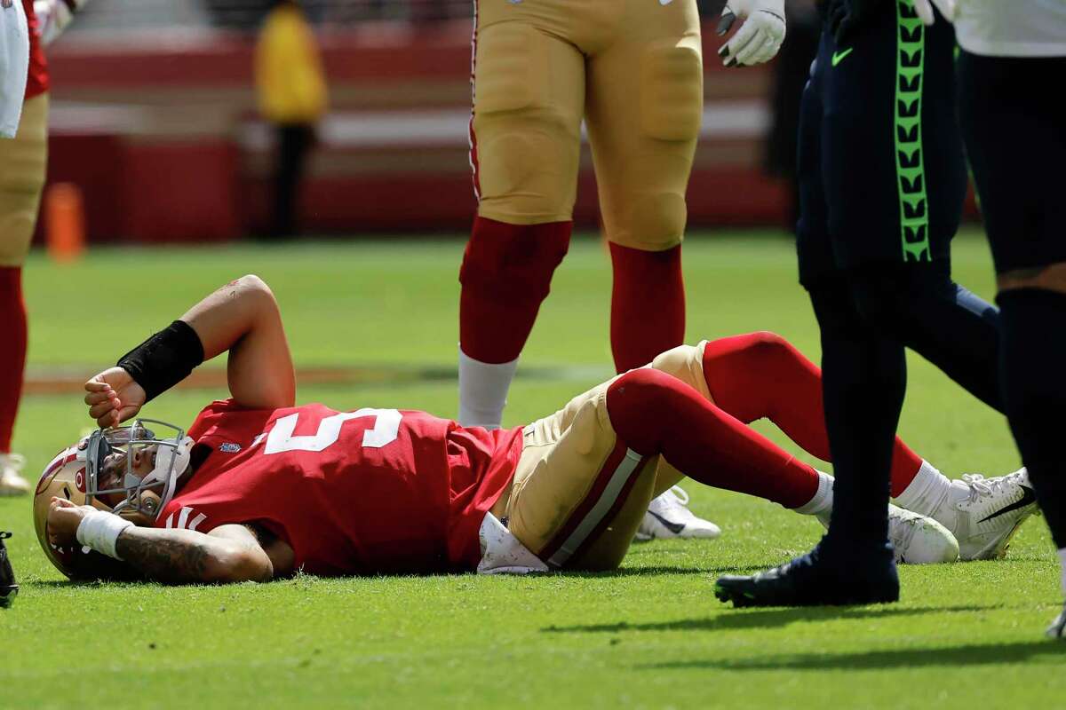 San Francisco 49ers quarterback Trey Lance gets up after being